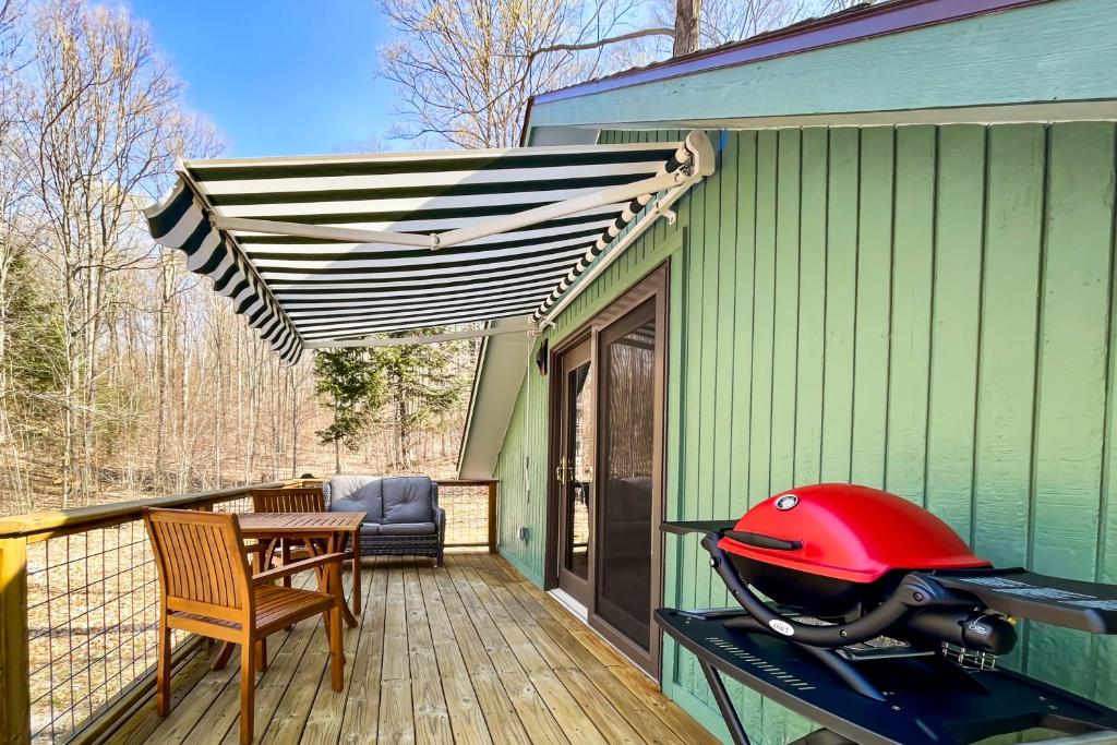 a red helmet sitting on a table on a deck at Half-Mile to Crystal Lake! Couples Retreat w/ Deck in Beulah
