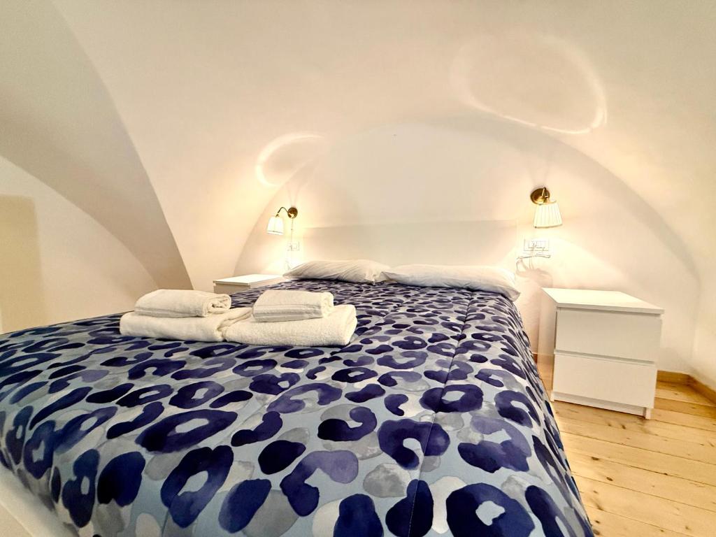 a bedroom with a blue and white bed with towels on it at Perla 19 - UN LETTO IDEALE in Gaeta