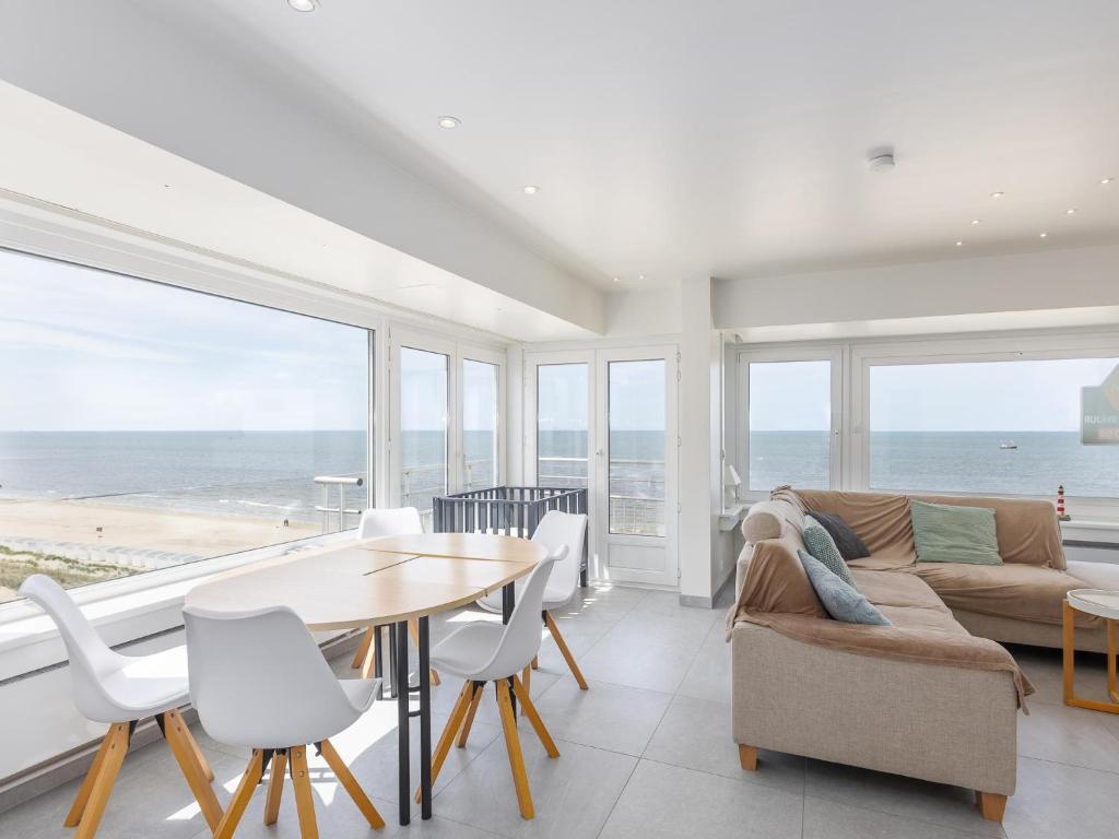 a living room with a couch and a table and chairs at Trianon - 0609 in Westende-Bad