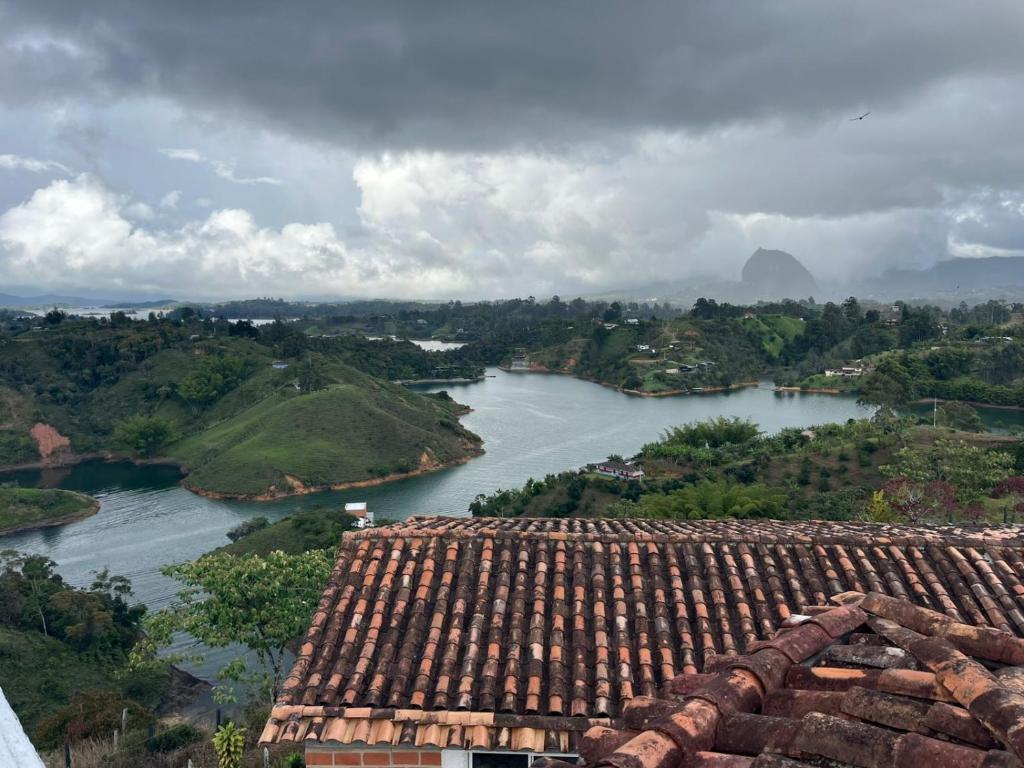 an aerial view of a river and a roof at Hotel Montañitas in Guatapé