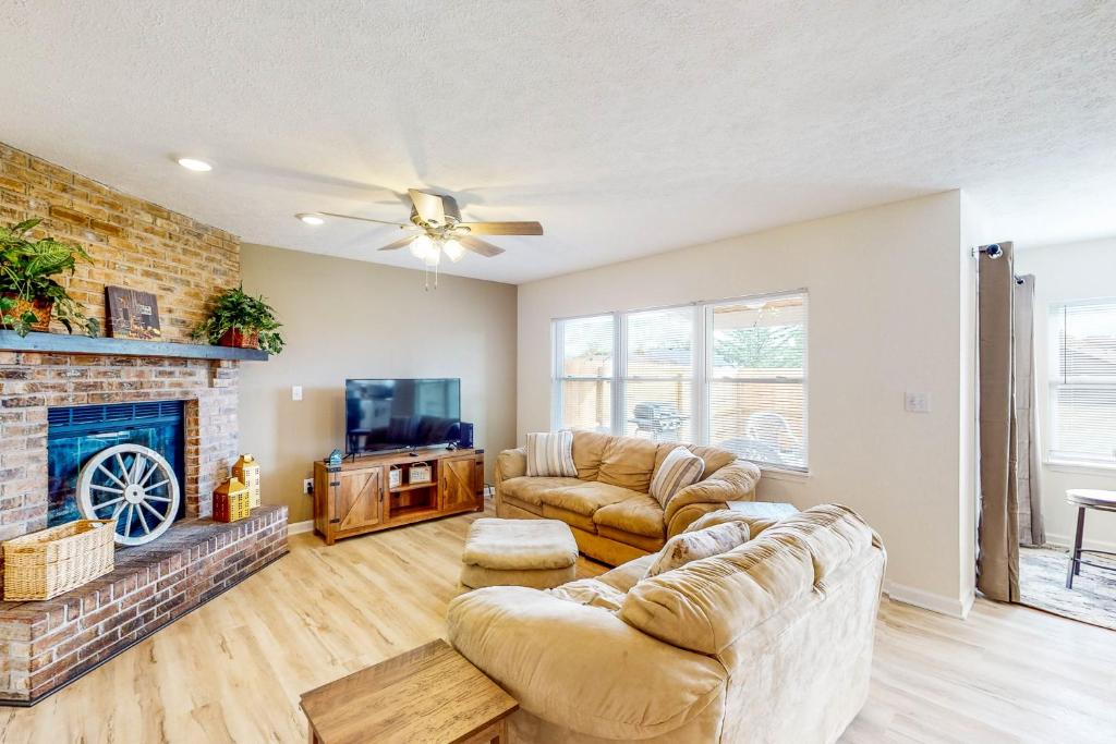 a living room with two couches and a fireplace at Indy Home w/ Dog-Friendly Yard! 9 Mi to Dtwn in Spring Hollow