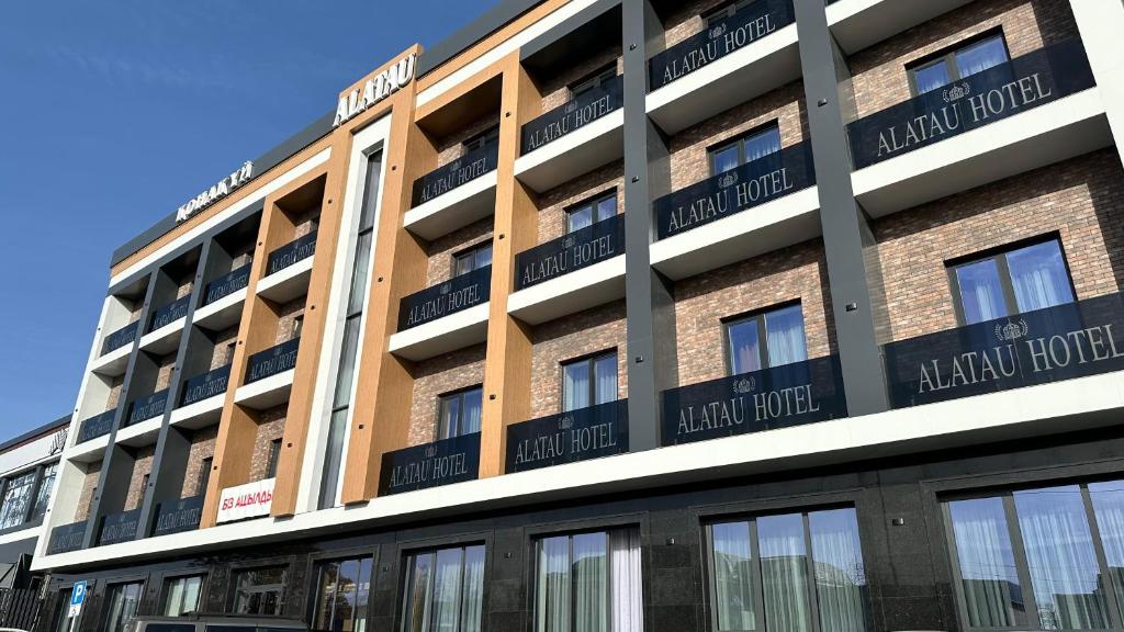 a building with signs on the side of it at Alatau hotel in Shymkent