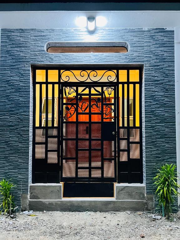 a front door of a house with a gate at Vaadhee Homestay in Guraidhoo