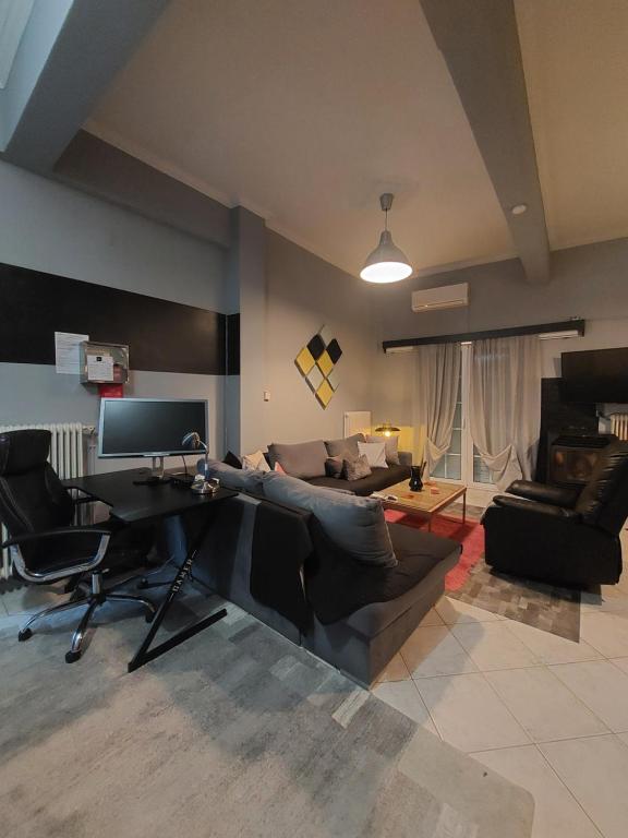 a living room with a piano and a couch at jim villa family apartment with private yard andravida-kyllini in Andravída