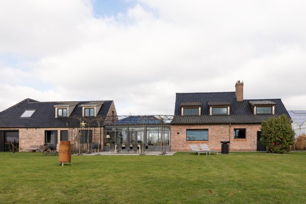 an image of a house with a lawn at Vakantiehoeve Breathe Nature in Lochristi