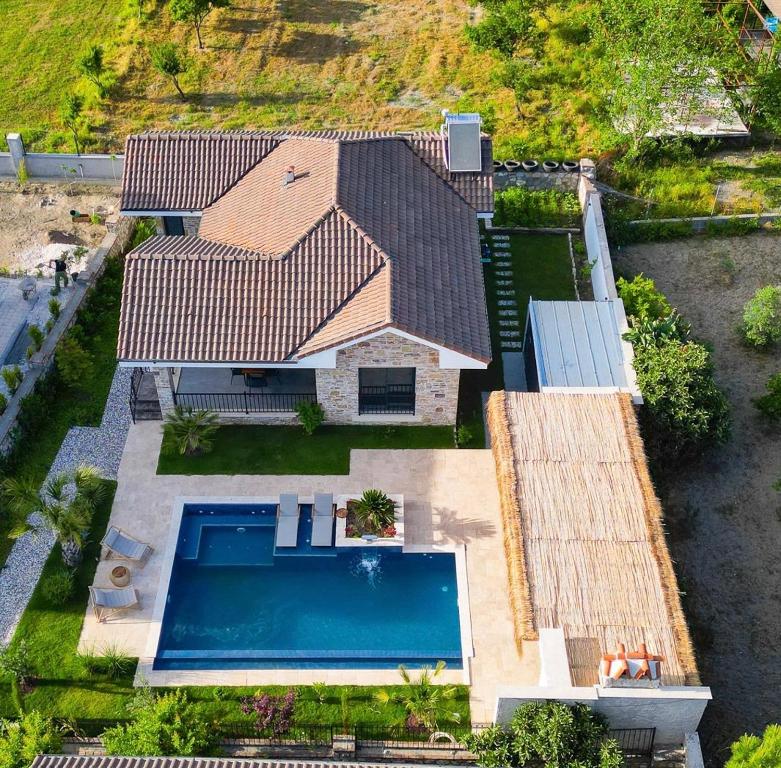 an aerial view of a house with a swimming pool at Citrus Stone House in Koycegiz