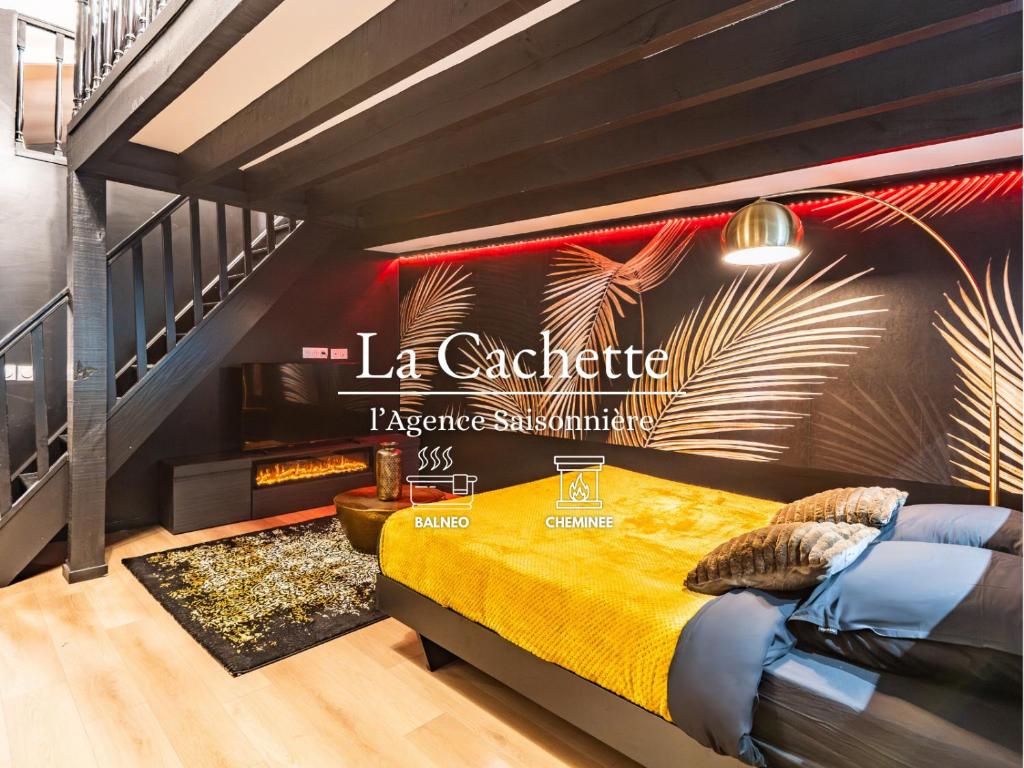 a bedroom with a bed with a sign on the wall at La Cachette - Suite romantique & balnéo privative in Hermeray