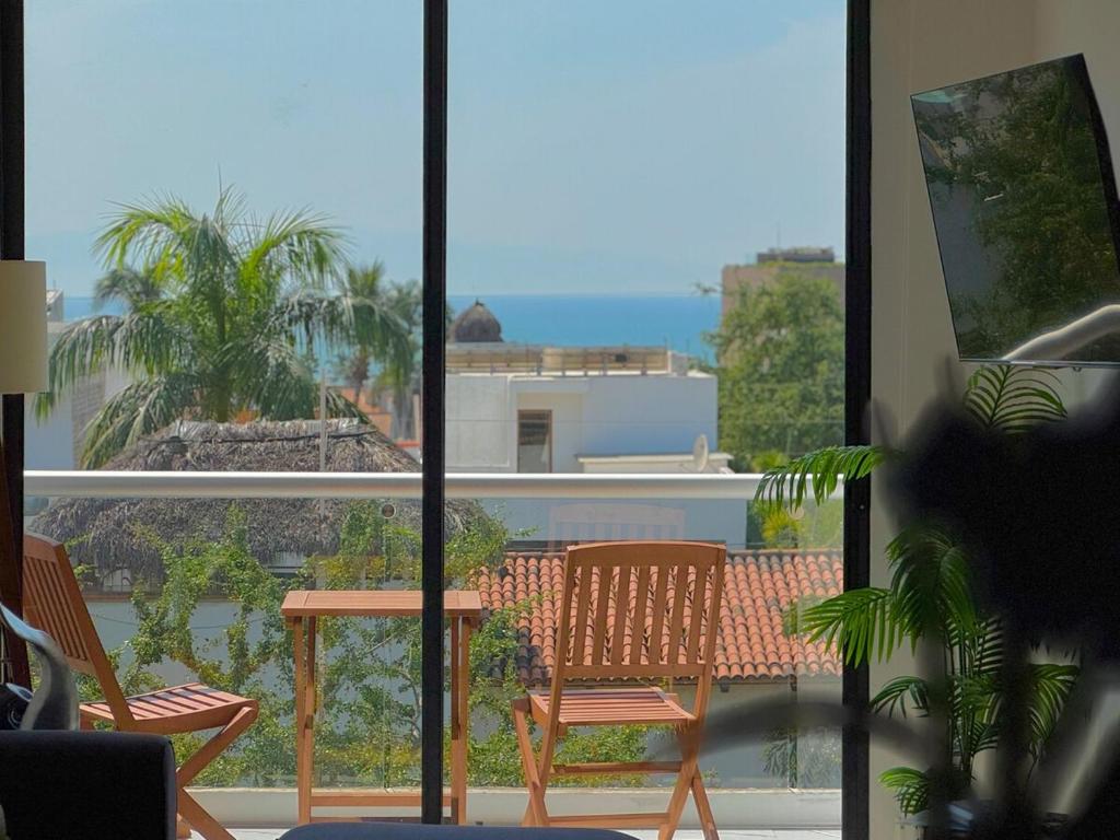 a view of a balcony with chairs and a table at 2BR Condo with Ocean View near beach in Bucerías