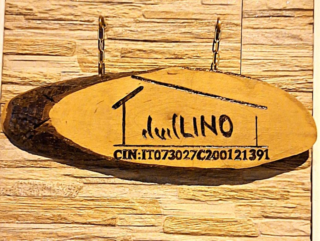 a wooden surfboard hanging on a wall at ilvilLINO in Taranto