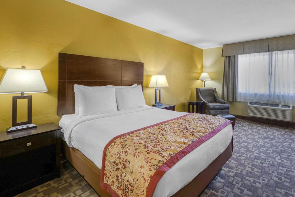 a hotel room with a large bed and a chair at Best Western Blackfoot Inn in Blackfoot