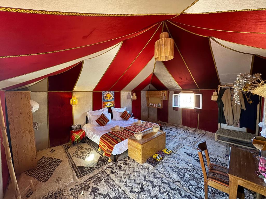 a bedroom with a bed in a large tent at Maria'S Luxury Camp in Merzouga