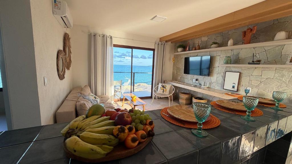a kitchen with a table with a bowl of fruit on it at Apartamento no Falesias de Pipa - Veleiros 212 in Pipa