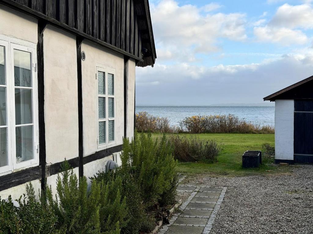 a white house with a view of the ocean at Beachhouse Humlebæk in Humlebæk
