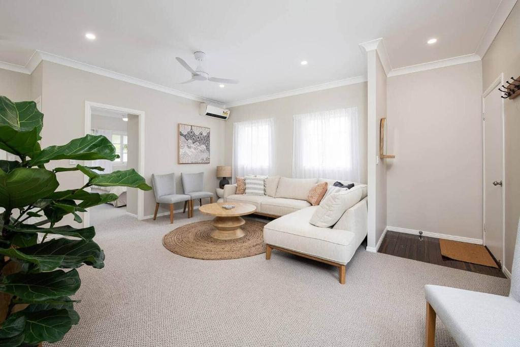 a living room with a couch and a table at Glass House Cottage in Glass House Mountains