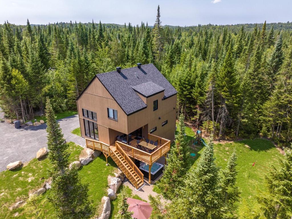 an aerial view of a house in the woods at Le Kouzy - Spa, Foosball, Pool table, Game Room in Sainte-Lucie-de-Doncaster