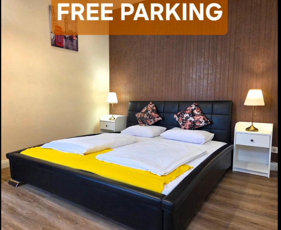 a bedroom with a large bed with yellow and white sheets at Garden House in Budapest
