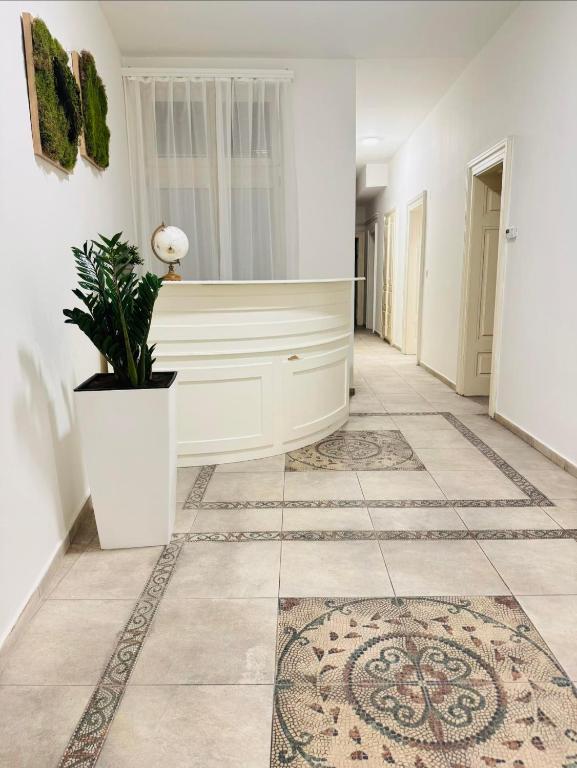 a hallway with a white console and a tile floor at Ostrava Apartment in Ostrava