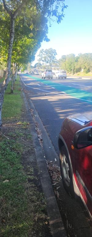 a red car parked on the side of a street at Aztec Adress 133 Beckett Road, mixed shared accommodation in Brisbane