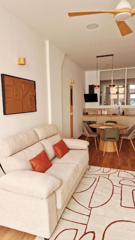 a living room with a white couch and a table at Sweet Apartment Aveiro Station in Aveiro