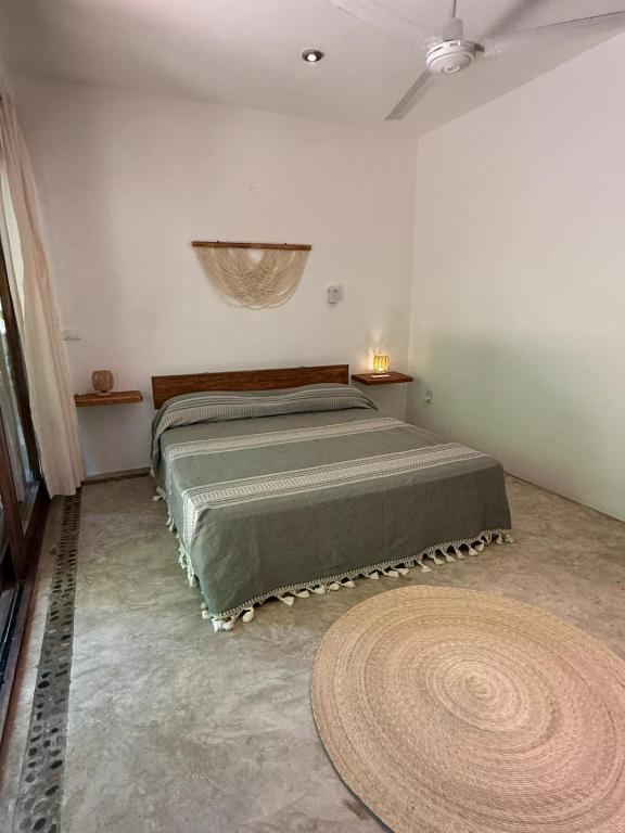 a bedroom with a bed and a large rug at La baxada mazunte in Mazunte