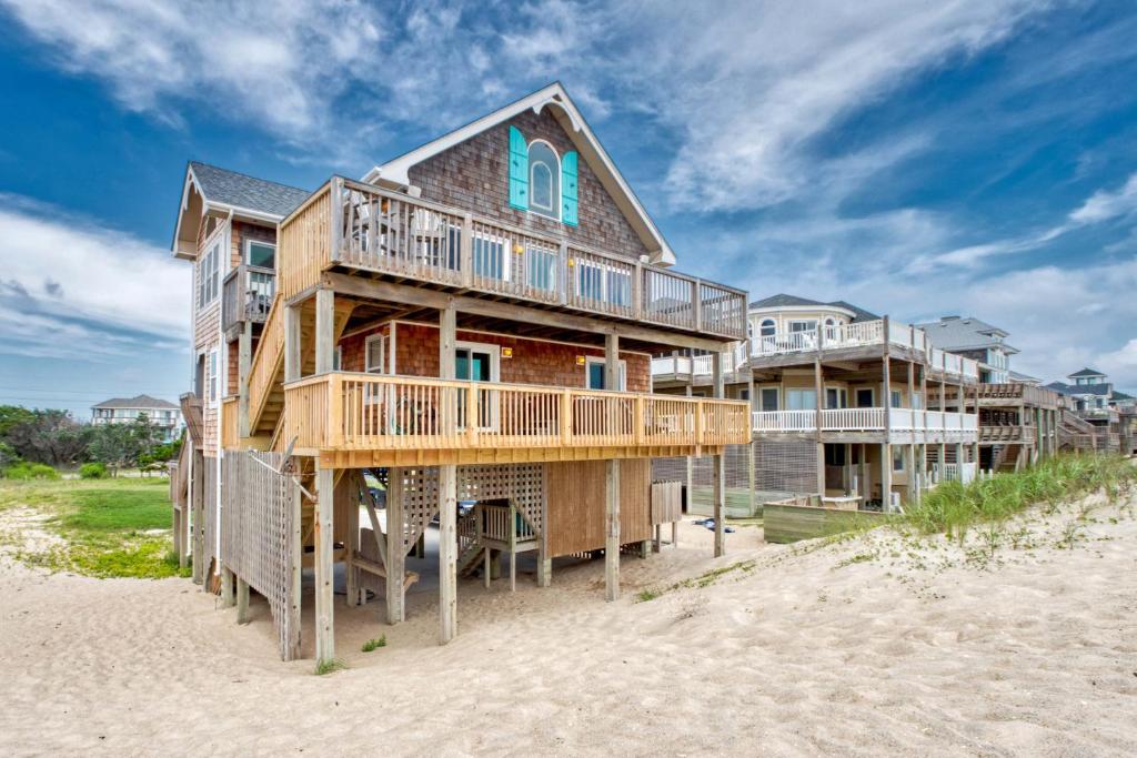 aominium building on the beach with a house at AV175 Sandfiddler 175 in Avon