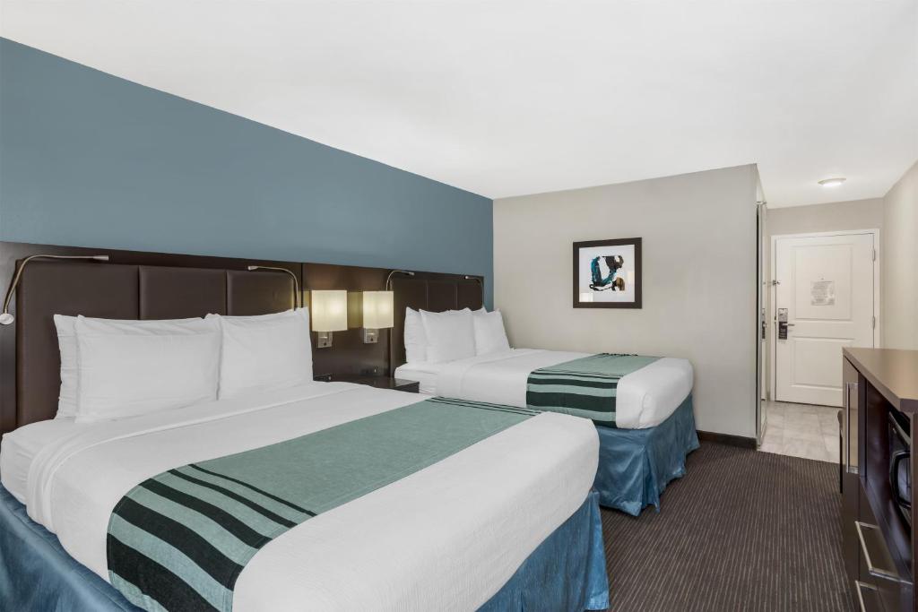 a hotel room with two beds and a tv at Best Western Plus Tallahassee North Hotel in Tallahassee