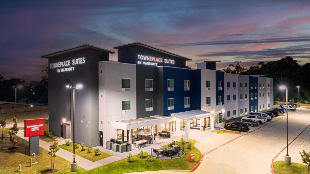 a large building with cars parked in a parking lot at TownePlace Suites Longview in Longview