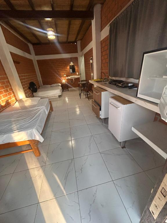 a living room with a tv and a couch at Punta Pacífico Bungalows Máncora in Máncora