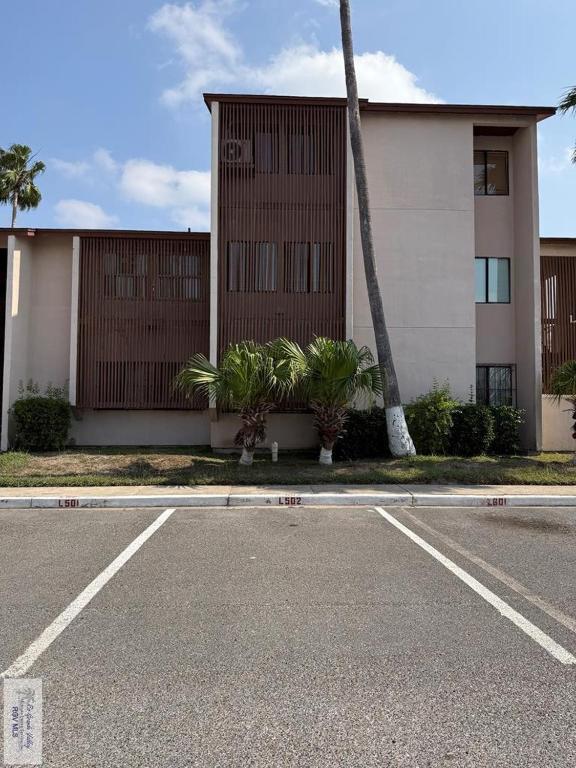 an empty parking lot in front of a building at 305 Calle Amistosa in Brownsville