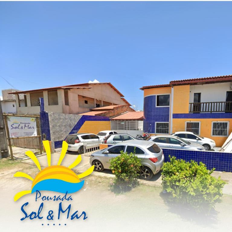 a sign for a sold and mm car dealership at Pousada Sol e Mar in Saubara