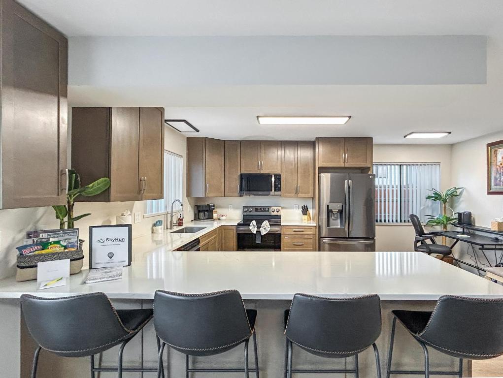 a large kitchen with a large white table and chairs at Gather Together home in Montrose