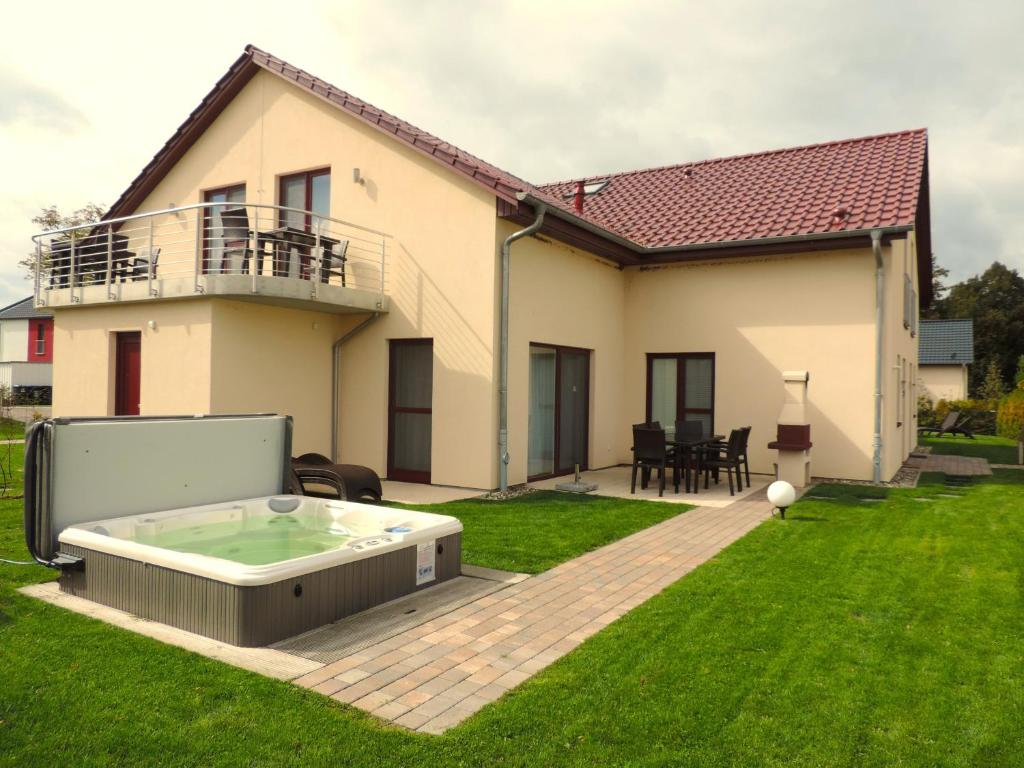 a hot tub in the yard of a house at Casa Cavallo in Göhren-Lebbin