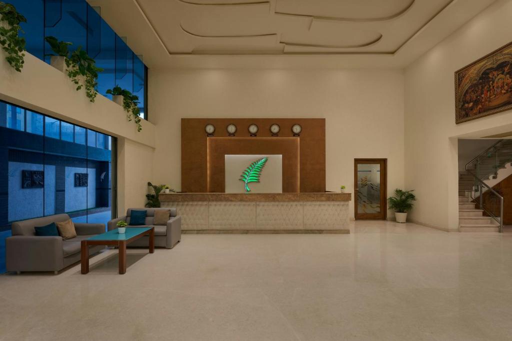 a lobby with couches and a counter in a building at The Fern Residency Bengaluru, Yeshwanthpur, Series by Marriott in Bangalore