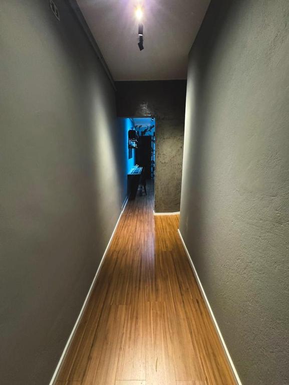 an empty hallway with a wooden floor in a room at Home Tatuapé in São Paulo