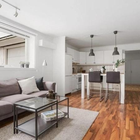 a living room with a couch and a table at Central 4 room apartment in Bergen