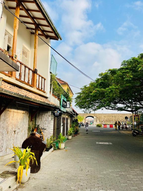 a street in a town with buildings and plants at Ayubowan Home in Galle