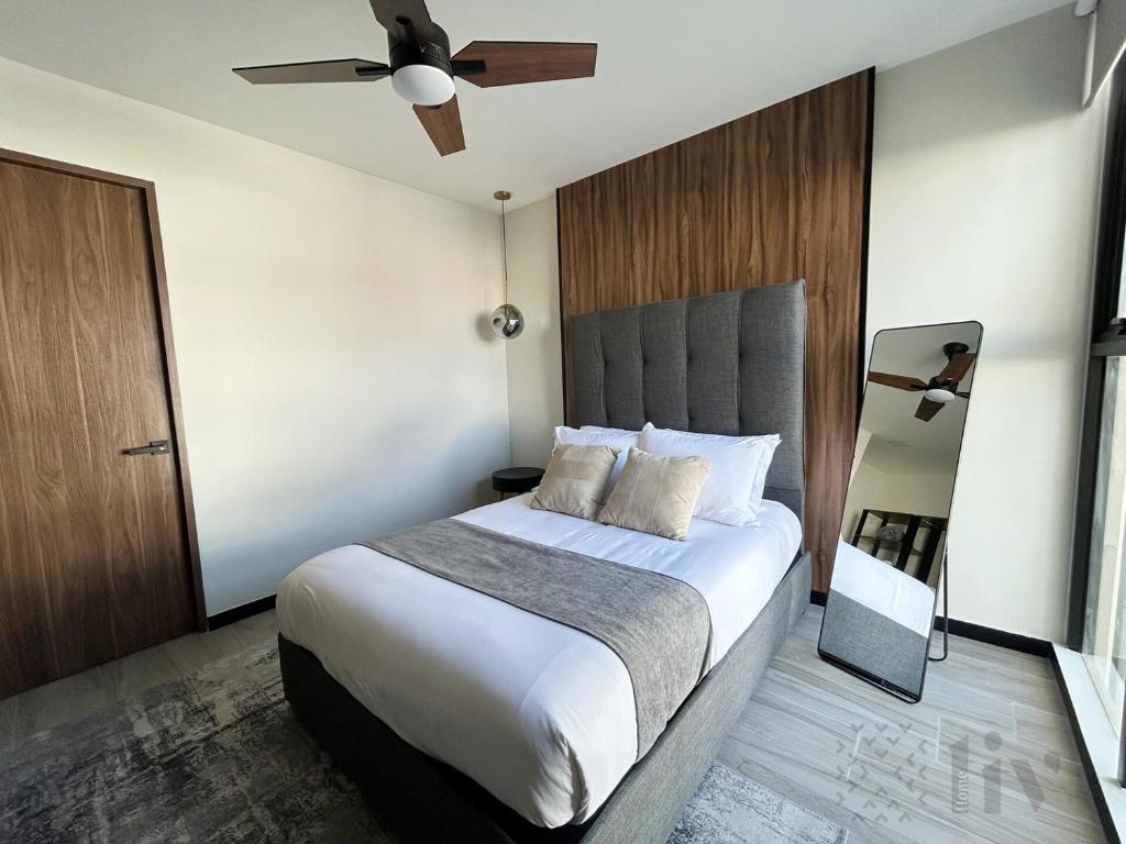 a bedroom with a large bed and a ceiling fan at Private Room w/ Ensuite Bath & top Amenities in La Cañada