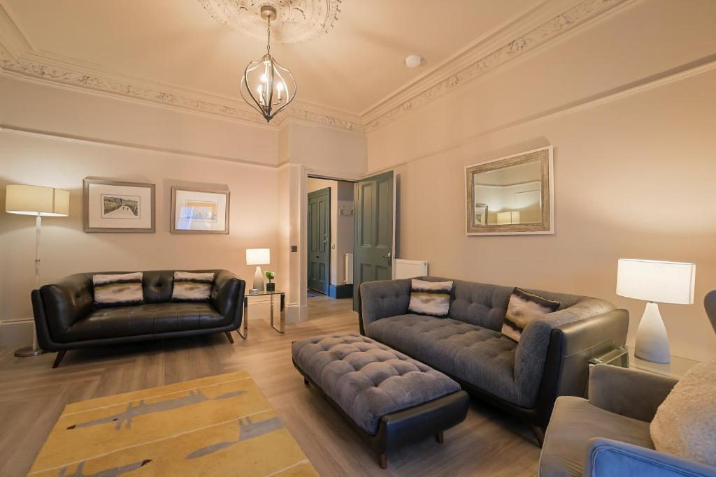a living room with two couches and a couch at Gordon's Getaway Lux in Oban