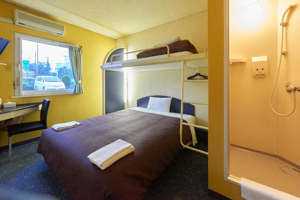 Postel nebo postele na pokoji v ubytování Select Inn Numazu