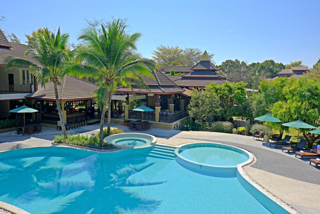 a large swimming pool in front of a resort at Mae Jo Golf Resort & Spa in San Sai