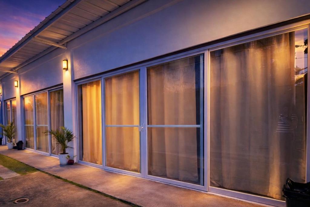 a building with large glass windows at Sundown Lodge in San Fernando