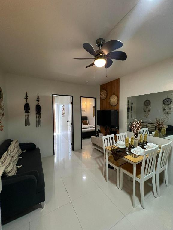 a living room with a table and a ceiling fan at B1 4Magnificent in Puerto Princesa City