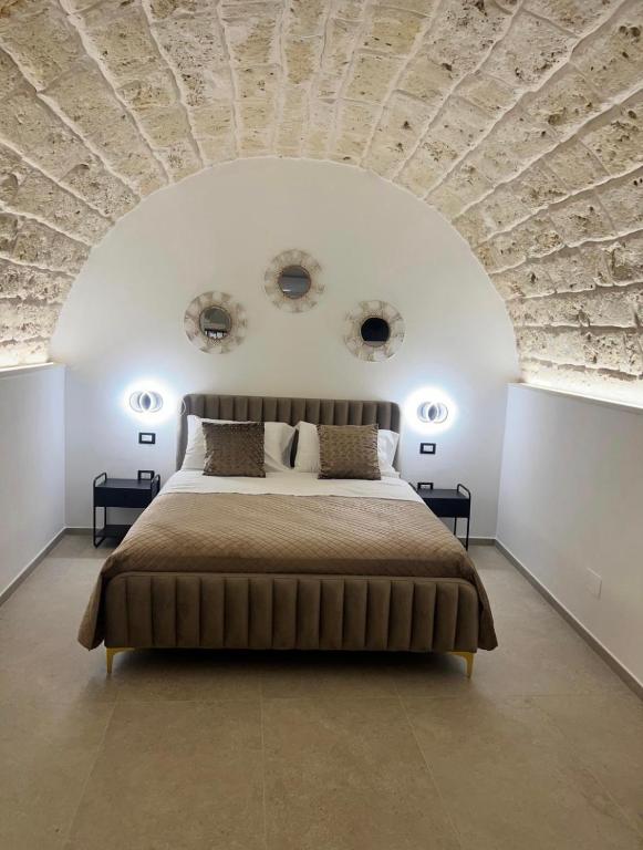 a bedroom with a large bed with a stone ceiling at Buonaventura house2 in Triggiano