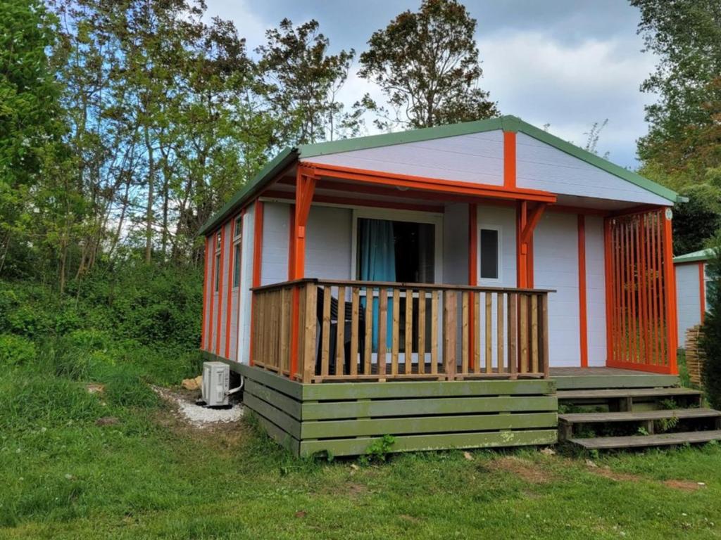 a small house with a porch on the grass at Chalet Confortable avec Terrasse - 5 pers - API-1-52-1957 in Pamiers