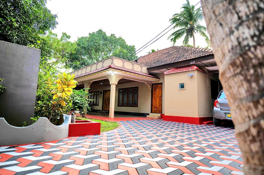a house with a brick driveway in front of it at Villa in Kalviyankadu in Irupalai