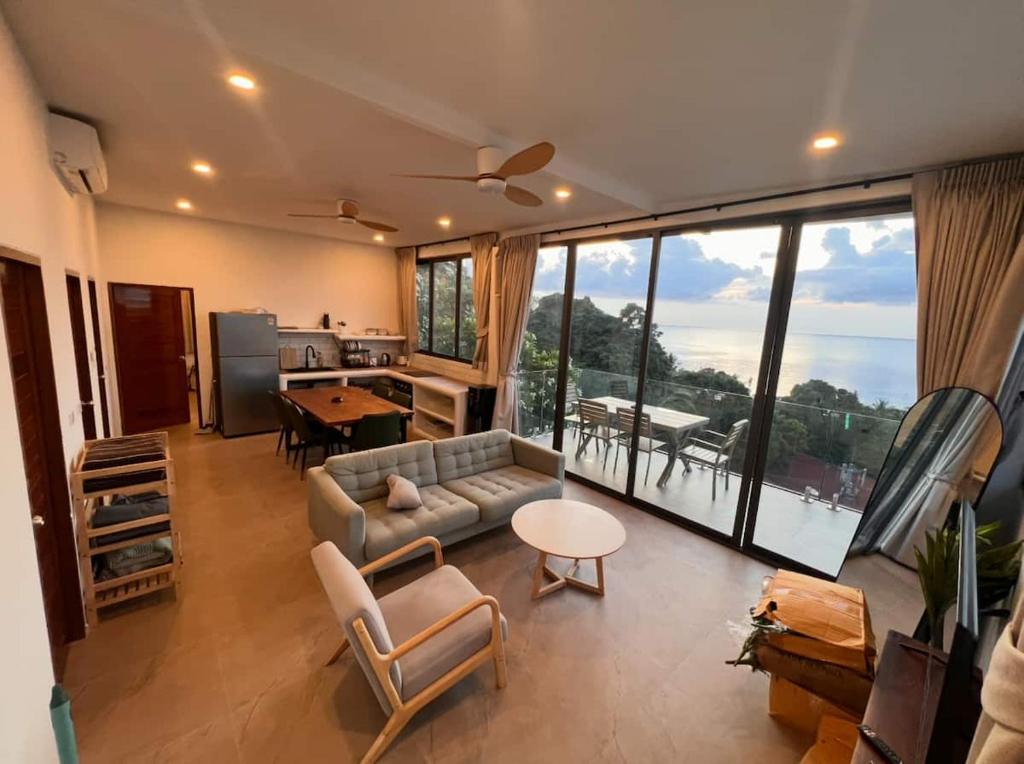 a living room with a couch and a table at Villa Narkis in Haad Yao
