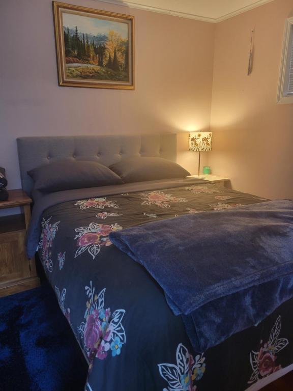 a bedroom with a bed with a blue comforter at Nice and cozy in Bremerton