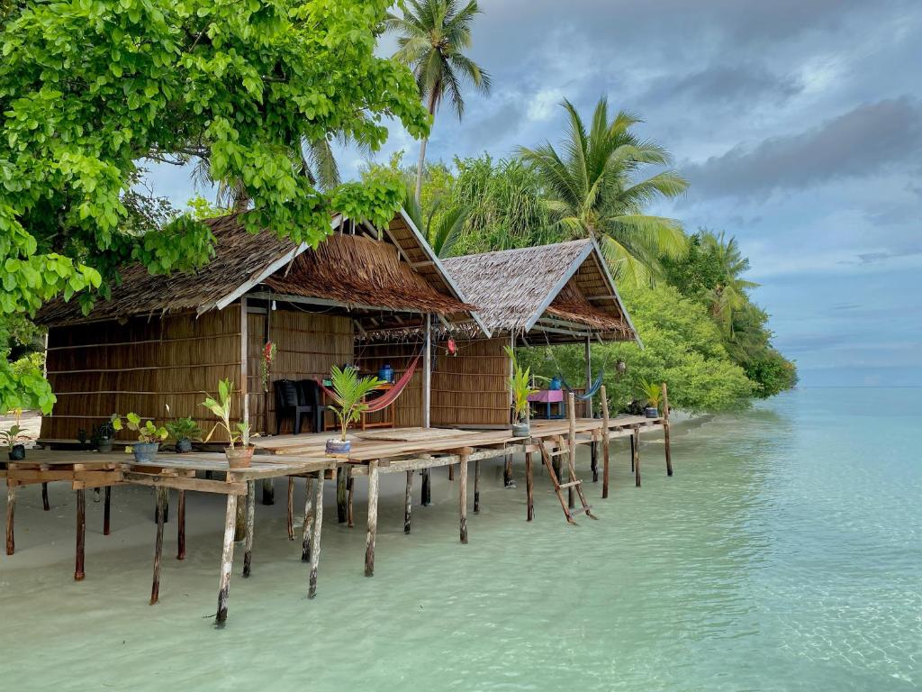 a resort on a tropical island in the water at Isiie Homestay in Merpati