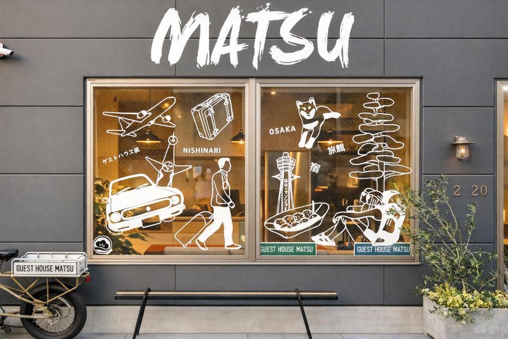 a mitzvah sign on the side of a store window at Guest House Matsu in Osaka
