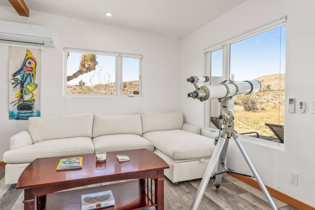 a camera in a living room with a couch and a table at Santorini with Stargazing - Views - Spa - Fire pit in Yucca Valley